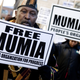PHILADELPHIA - DECEMBER 9: Supporters of death-row inmate Mumia Abu-Jamal rally outside City Hall December 9, 2006 in Philadelphia, Pennsylvania. The rally marked the 25th anniversary of the night Philadelphia police officer Daniel Faulkner was fatally shot. Abu-Jamal was later convicted of first degree murder for Faulkner's slaying. (Photo by Jeff Fusco/Getty Images)
